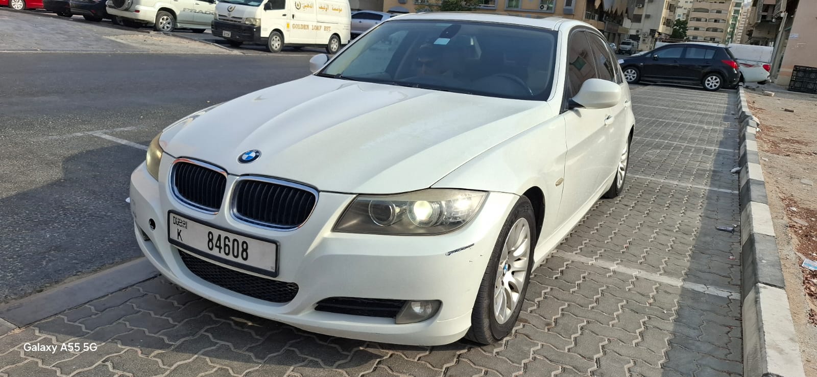 White BMW 3 Series at the garage