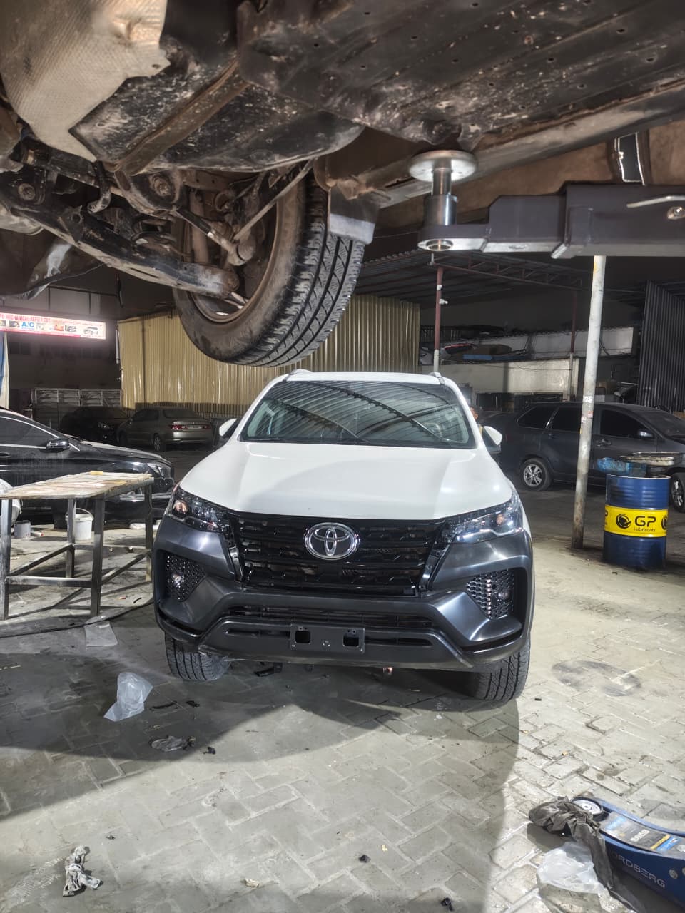 Toyota Fortuner on the lift for an underside inspection