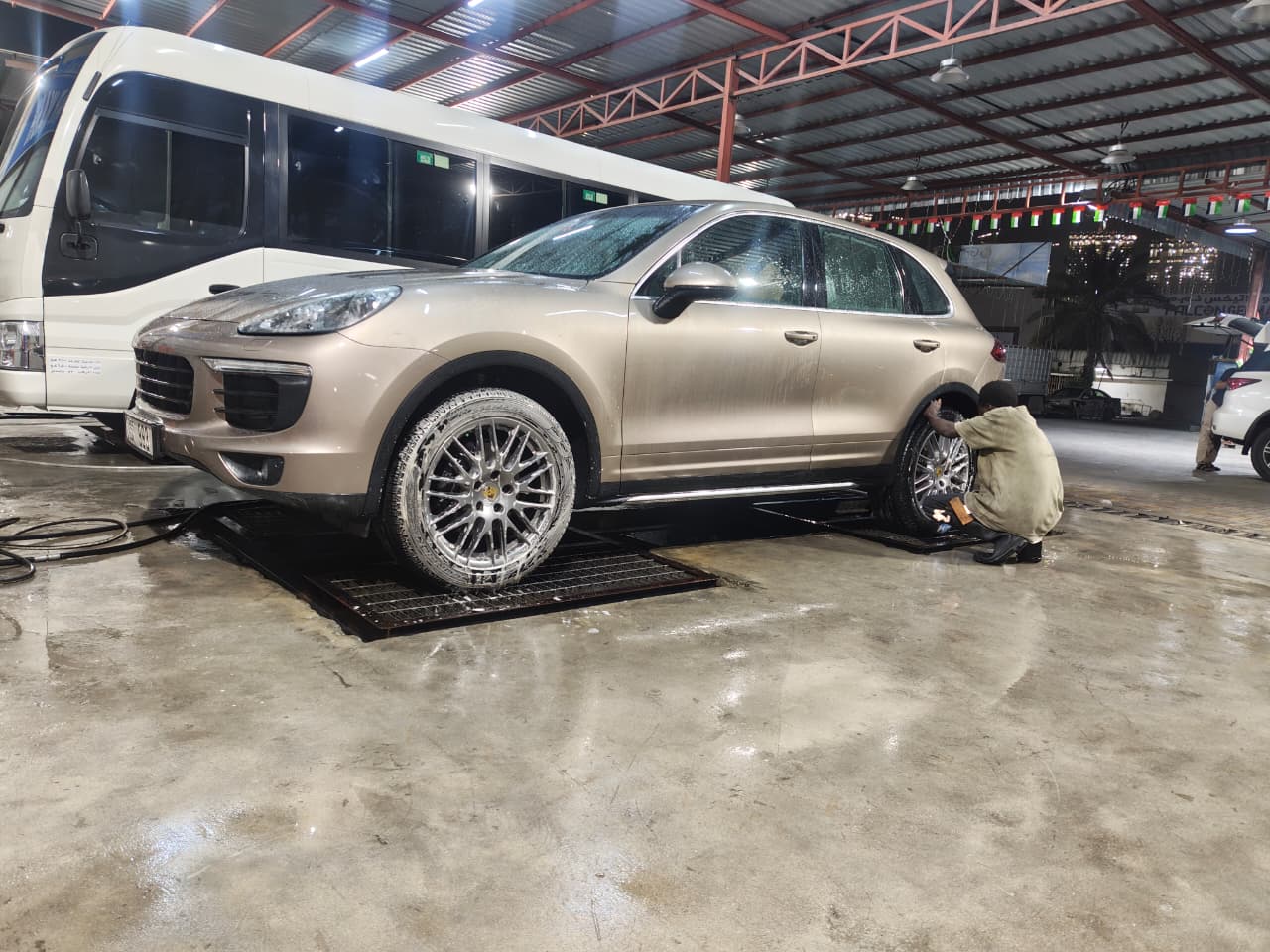 Porsche Cayenne being hand washed on the detailing bay
