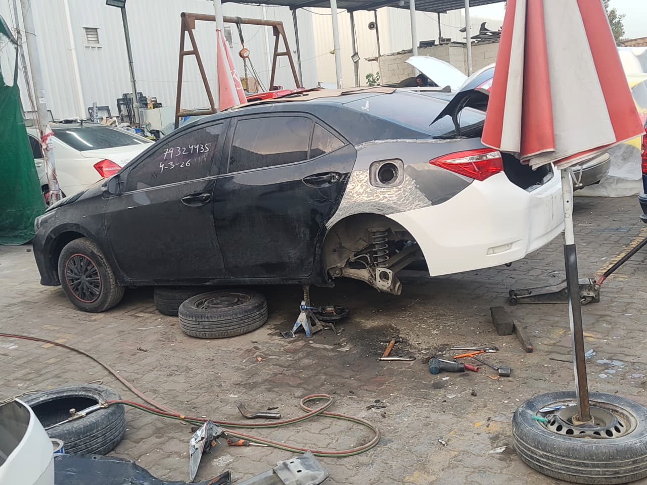 Vehicle on jack stands during bodywork